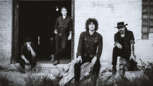 Black and white image of Xixa band members outside.