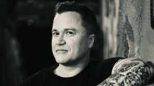 Photo of CR Robbins, singer-songwriter, in black and white.