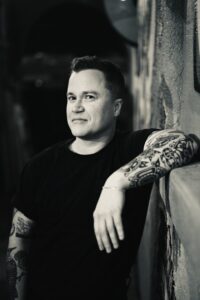 Photo of CR Robbins, singer-songwriter, in black and white.